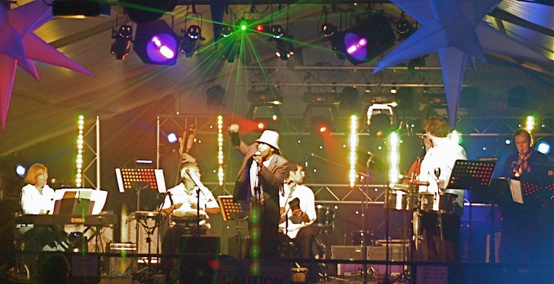 Live Salsa Band Jan y su Salsa at a corporate event at Silverstone race course, singer Enrique in foreground