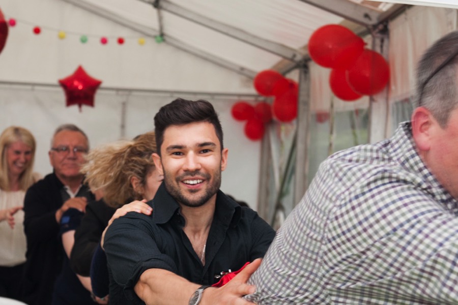 Dancer Alex in a conga line at a birthday party in Wiltshire
